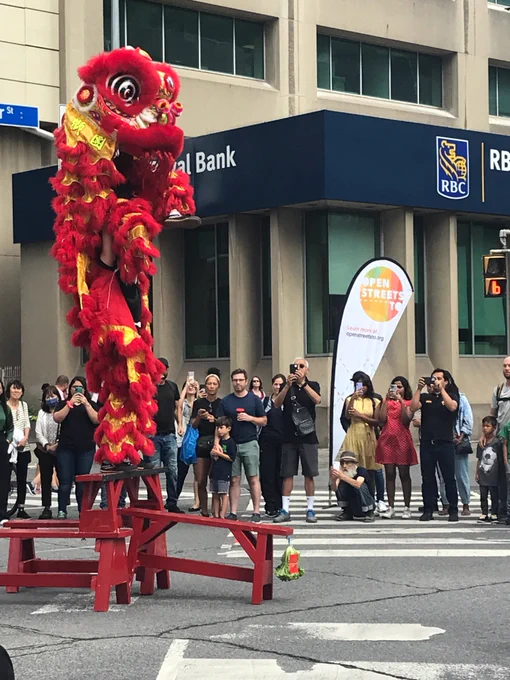 A red and gold dragon dancer pair getting really tall.