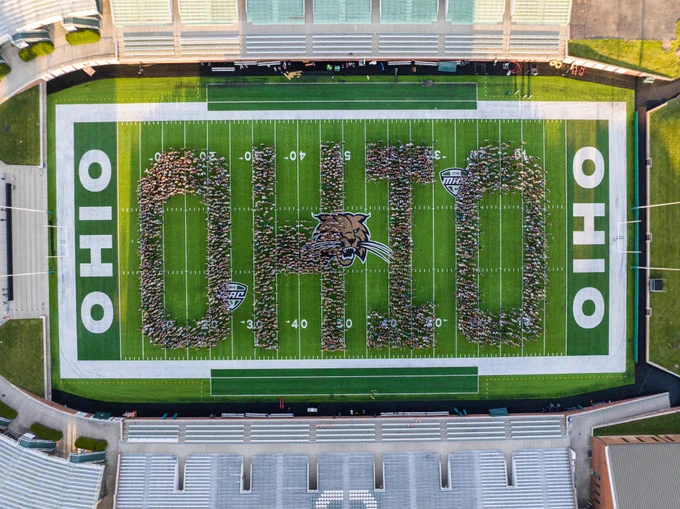 The OHIO Class of 2026 students form the word "OHIO" on Frank Solich Field at Peden Stadium.