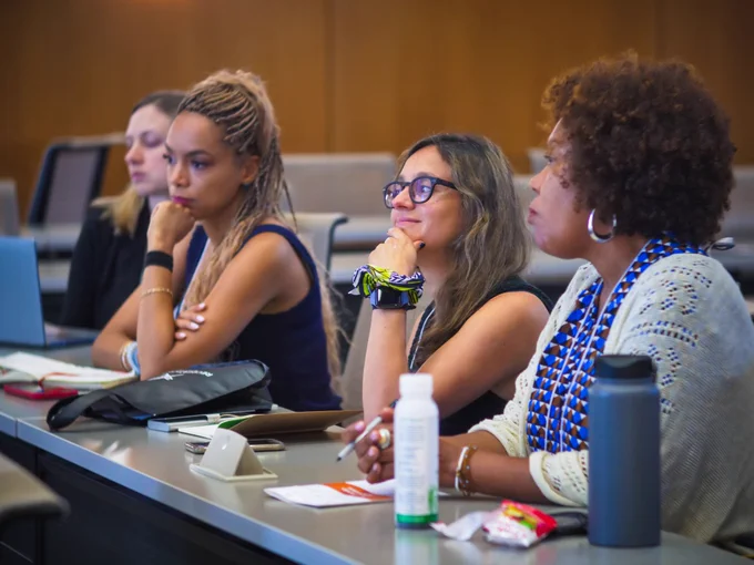 Group of four UT faculty sitting and listening intently to a speaker at NFS 22.