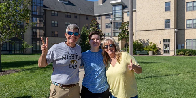 Mizzou family poses together outside res hall