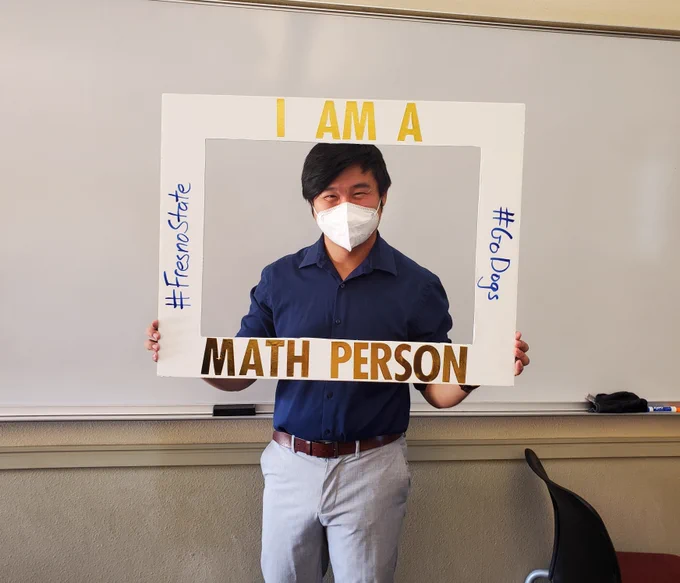 A picture of me with a frame that says "I am a math person" with hashtags "Fresno State" and "Go Dogs"