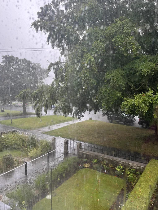 View from window over front gardens with heavy rain