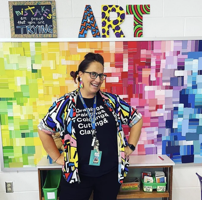Margaret McDonald standing in front of a colorful wall. 
