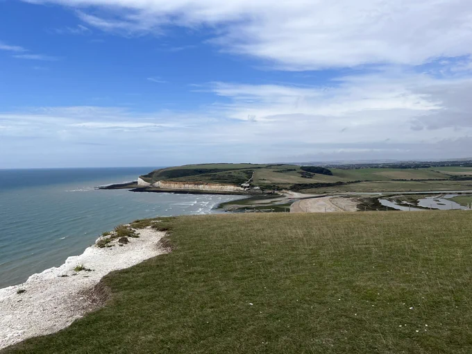 White cliffs with grassy hilltop overlooking the sea