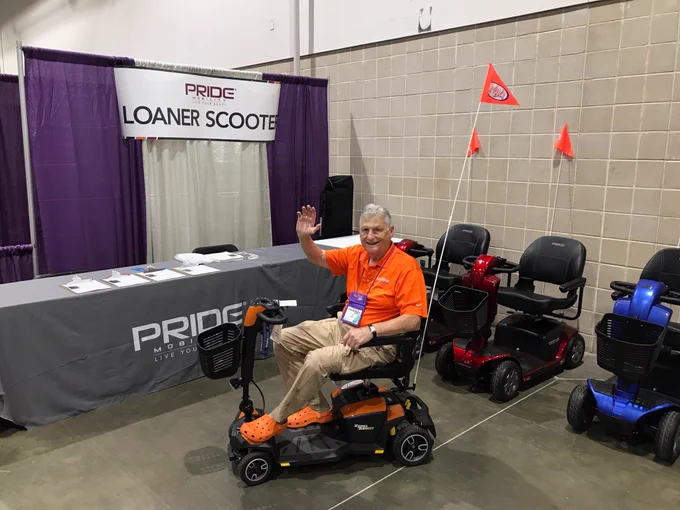 Man waving on scooter