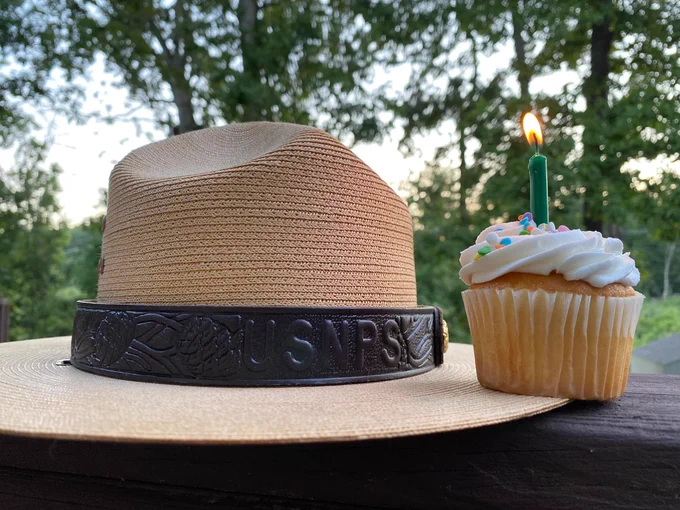 Ranger hat next to a cupcake with candle