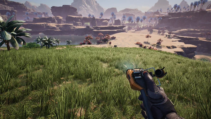 First person view from the player character in Satisfactory looking out on the landscape of the planet. In her right hand she holds the build gun aiming out at the environment. The environment borders between lush green fields and a rocky desert with palm trees.