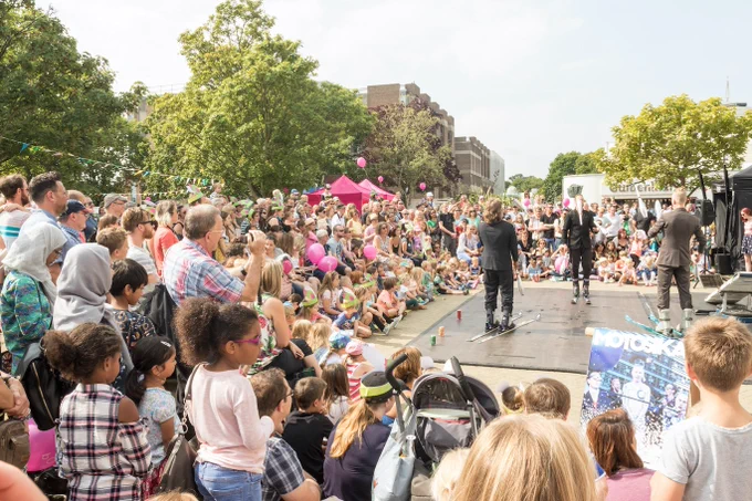 A big crowd watches a live performance at the bOing! family arts festival at the University of Kent