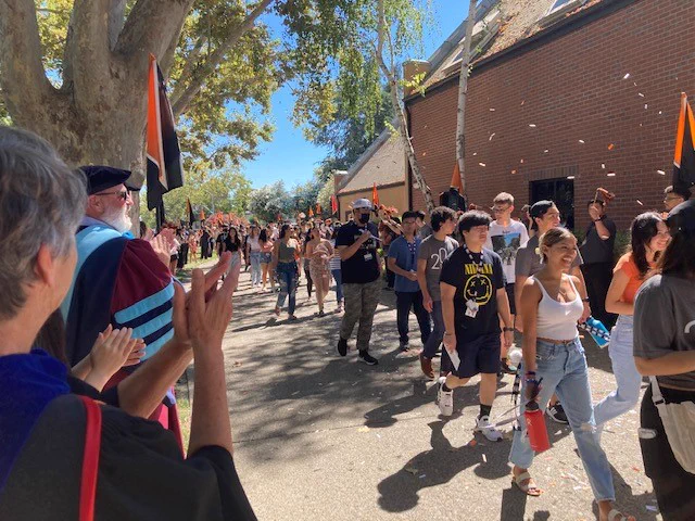 Provost Maria Pallavicini & VP Chris Ferguson applaud new Pacific students, with our amazing Pacific Pep Band in background.