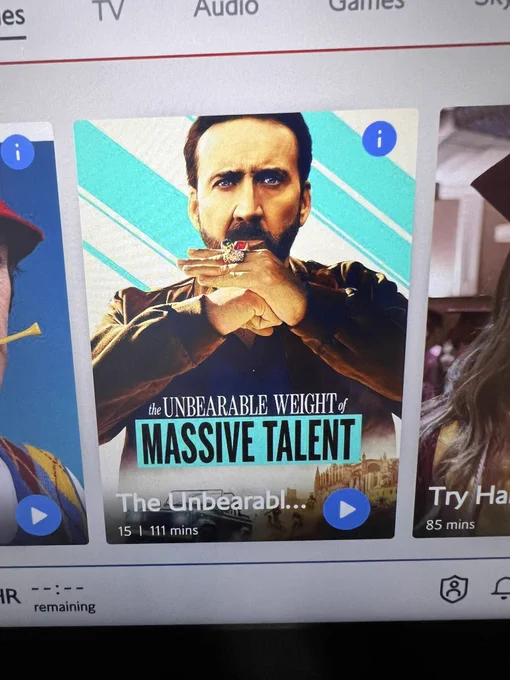 Picture of a seat back inflight entertainment screen, with the thumbnail image of The Unbearable Weight of Massive Talent movie.