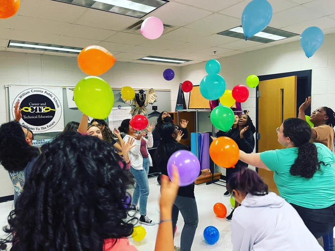 Students are keeping balloons afloat.