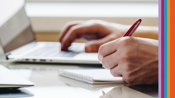 Person writing and using computer with WRITE Festival stripes down the right side.