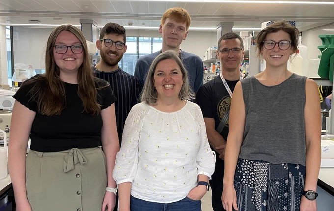 Group photo of 6 scientists in lab
