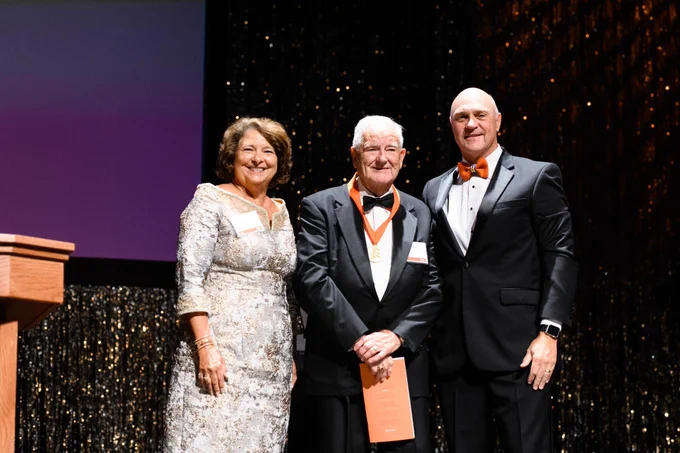 Dr. Charles Watt, President Jim Clements and Chair Kim Wilkerson smile on stage during the Clemson Medallion Ceremony.