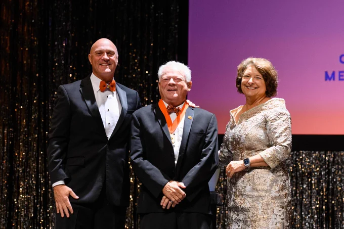 Dr. Bobby McCormick, President Jim Clements and Chair Kim Wilkerson smile on stage during the Clemson Medallion Ceremony.