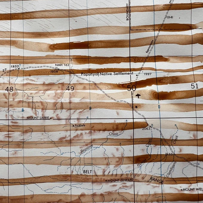 A small detail of an old topographic map with pale red ochre stripes running horizontally. Details of the original map can be seen
