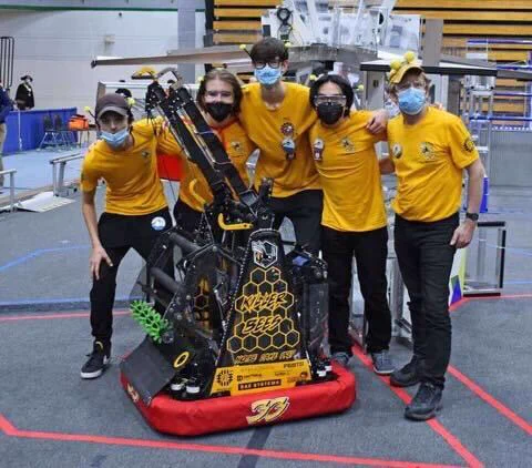 21-22 Drive Team celebrating the first win of the season, image of 5 Killer Bees and the 2022 robot.