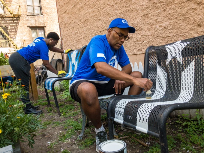 Volunteers from The Mission continues paint chairs