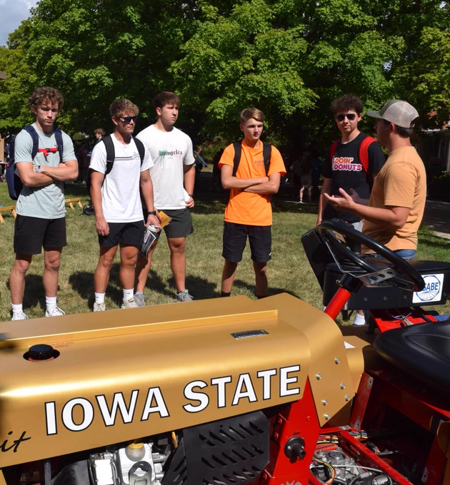 Students examine a tractor