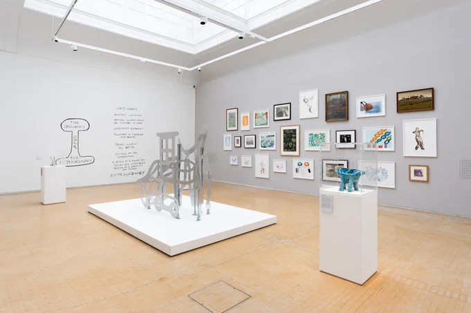 View of the exhibition including three sculptures at the front and a salon hang at the back with works on paper by Jill McKnight and from Leeds Art Gallery's collection