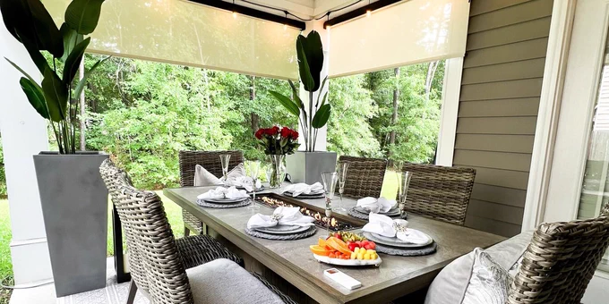 Outdoor patio with motorized solar shades and outdoor dining area.