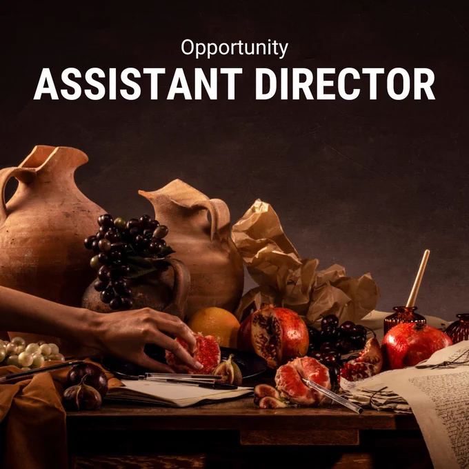 A photograph of a table laden with decaying fruit and clay jugs and pottery. A hand reaches into shot, sticking their fingers into the fruit. Text in white letters reads: Opportunity Assistant Director.