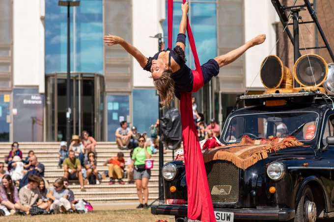 Pirate Taxi crew member performing acrobatically as the crowd watches on 