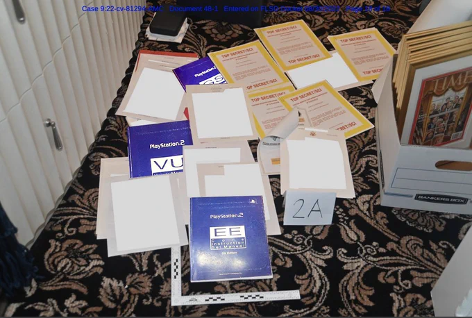 Photo of secret documents found at mar-a-lago with some (badly photoshopped) PS2 technical reference manuals added.