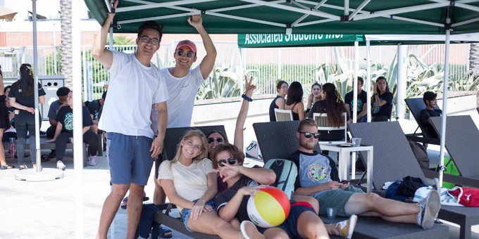 Students huddle together & lounge by the BRIC pool. 