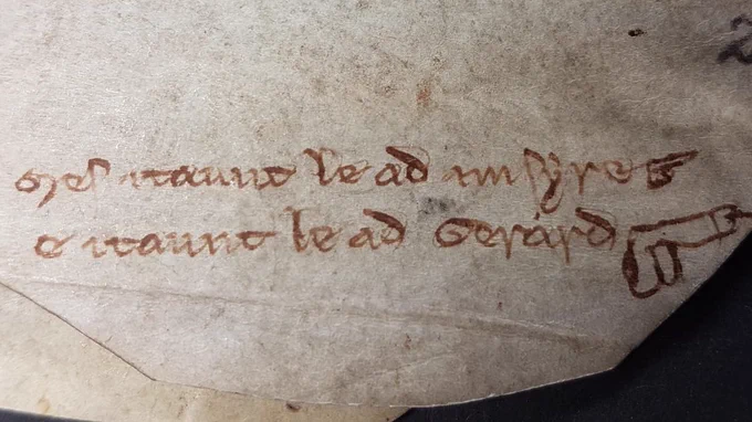 The doodle at the bottom of a 1250s legal record, showing one small penis and one larger penis