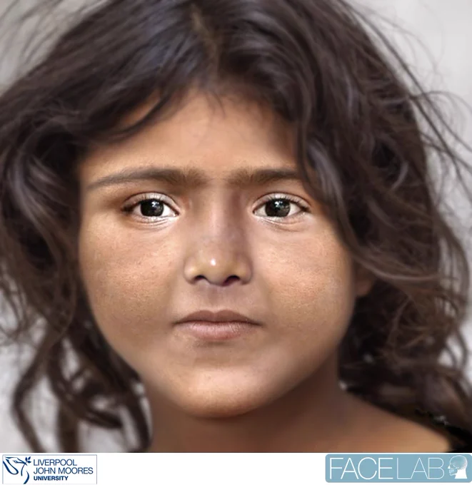 Facial reconstruction of a young girl with dark olive skin, brown eyes and long flowing brown hair. She has a small slightly downturned mouth, a narrow nose and large eyes.