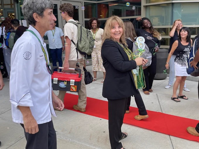 Staff and administration at Emmett O'Brien Technical High School greet students for their first day of school with a red carpet celebration. 