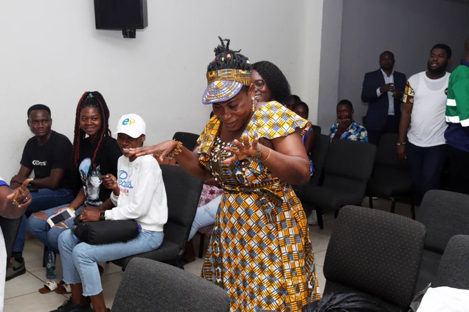 A woman dancing to the tune as we were waiting for the  results 