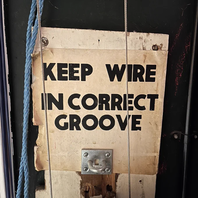 Backstage sign saying Keep Wire in Correct Groove