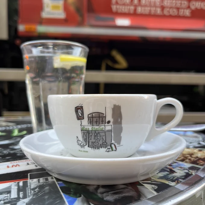 A cappuccino from Bar Italia on a table outside