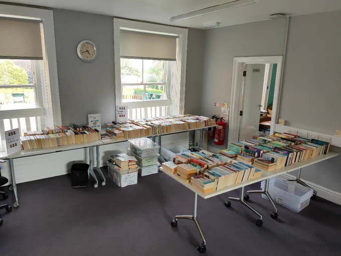 Hundreds of books laid out on tables in the Tottington Centre.