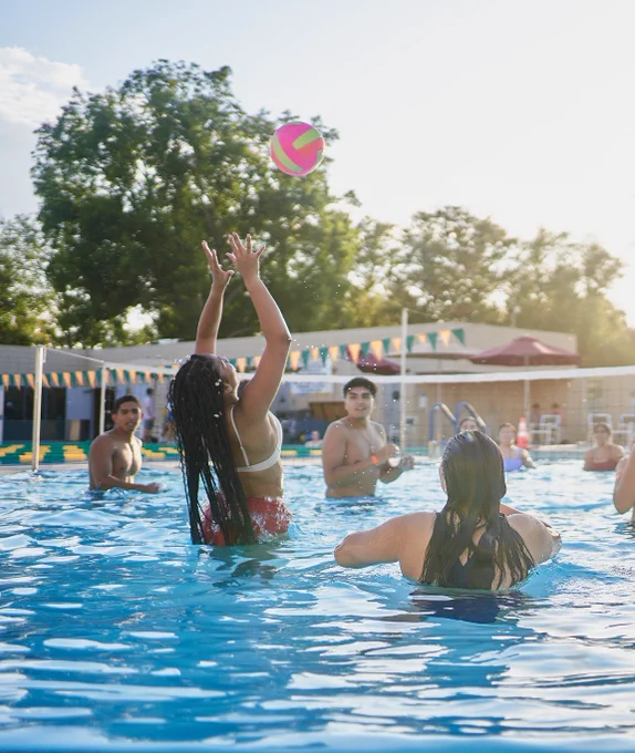 A group playing pool volleyball at the BRIC Pool.