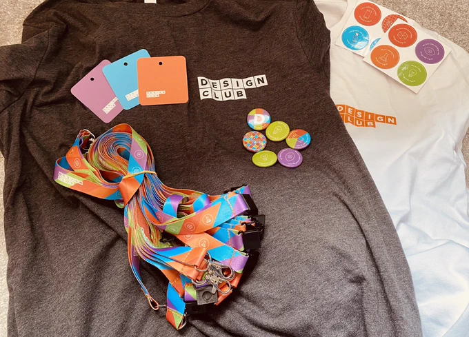 Mixture of design club resources including t-shirts, badges, stickers and lanyards.