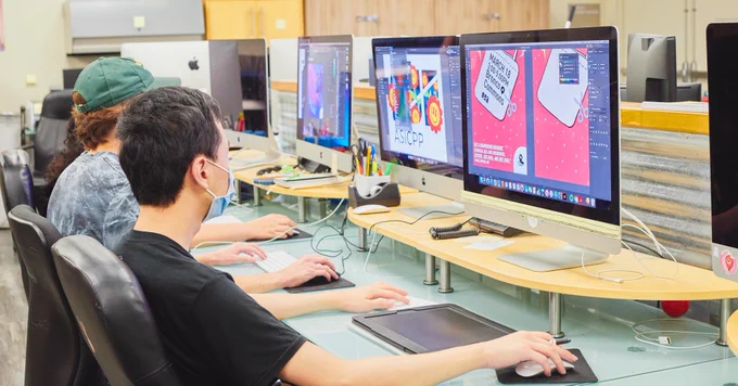 A row of students developing a graphic for ASI. 