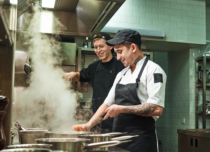 Restaurant employees working together in the kitchen.
