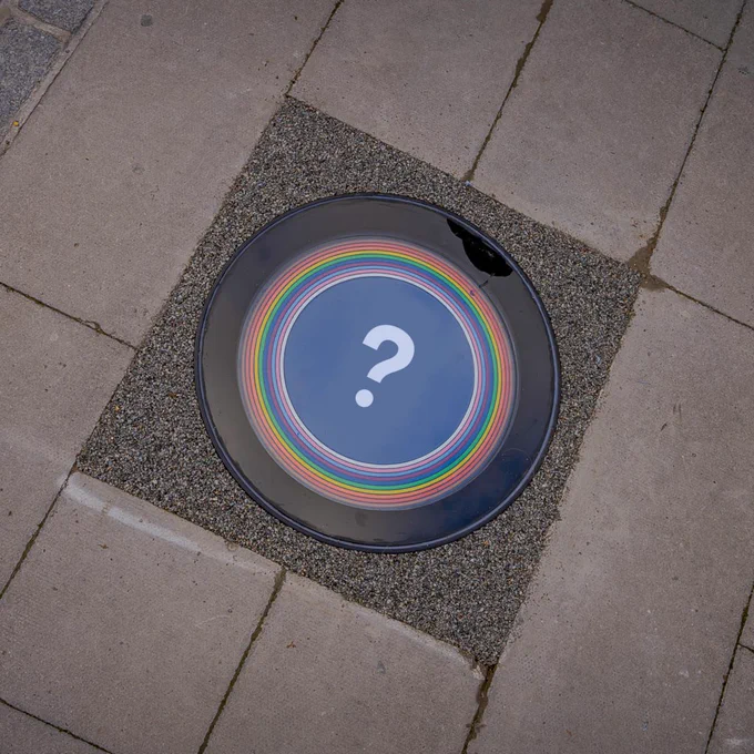 Rainbow plaque to celebrate LGBTQIA  history with question mark in centre - inviting people to suggest who should be there