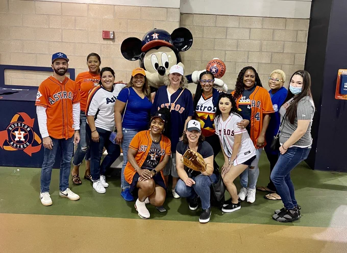 Team members of the Multi-Tiered Systems of Support Office posing for a group picture in Astros gear