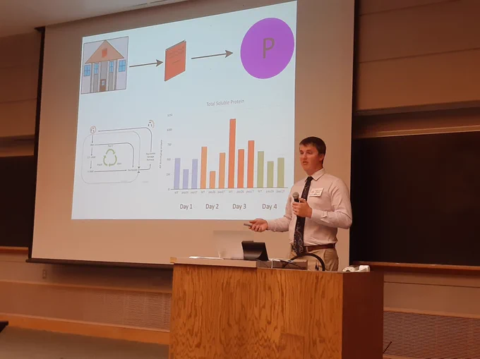 Prescott, undergrad in biochemistry at Iowa State University, presenting his research using a PowerPoint slide
