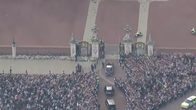 an aerial photo showing many thousands of people in front of the palace