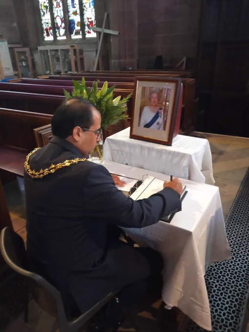 The Mayor of Rotherham, Cllr Tajamal Khan signs the Book of Condolence
