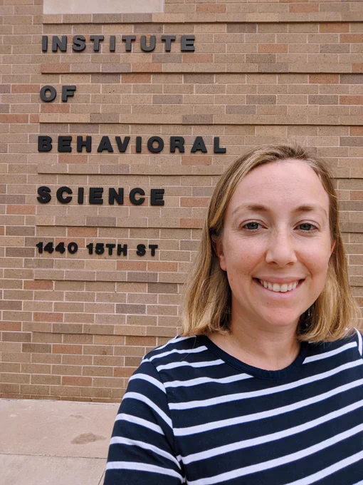 Photo of Jessica Finlay in front of the Institute of Behavioral Science buliding
