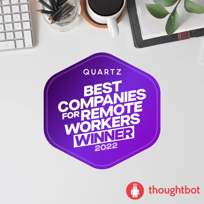 image of a desktop scene with keyboard, pencil cup and coffee cup with Quartz and thoughtbot logos and text reading Quartz Best companies for Remote Workers Winner 2022. 