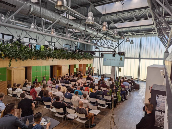 Photo of opening speaker and audience at measure Camp Czechia, Brno