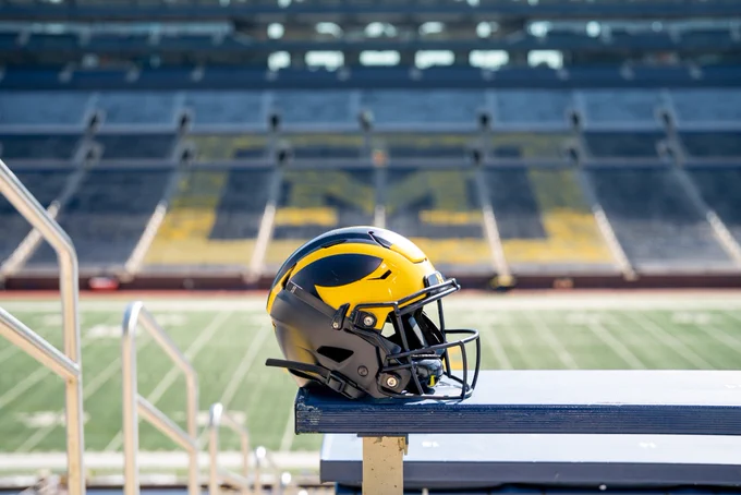 The Michigan football helmet rests on the bleachers inside Michigan Stadium