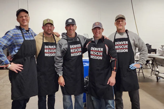 5 men in a row in aprons smiling